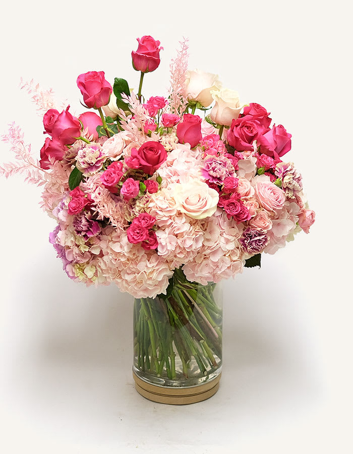 Pink and white rose bouquet in a clear glass vase