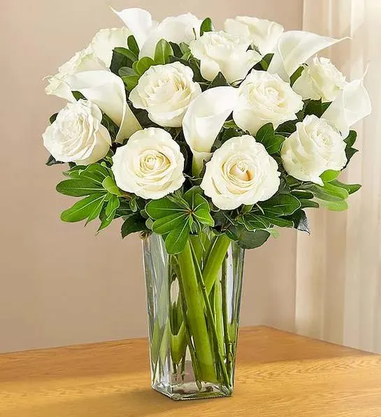 White Rose &amp; Calla Lily Bouquet for Sympathy - Convey your deepest sympathies with our elegant all-white arrangement. One dozen lovely roses are paired with five calla lilies, creating an expression of graceful beauty during this difficult time.
