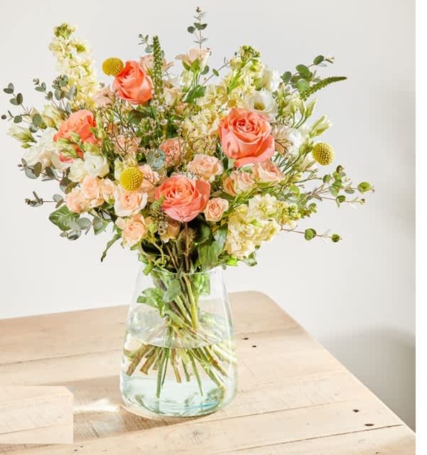 peach citruses bouquet - Like that first bite of a plump and juicy fruit on a sunny day, the Apricot Aura exudes a sweetness that is to be savoured. Sunbeam yellow, peach and cream blooms tumble across each other like a boon of sun-soaked citruses.