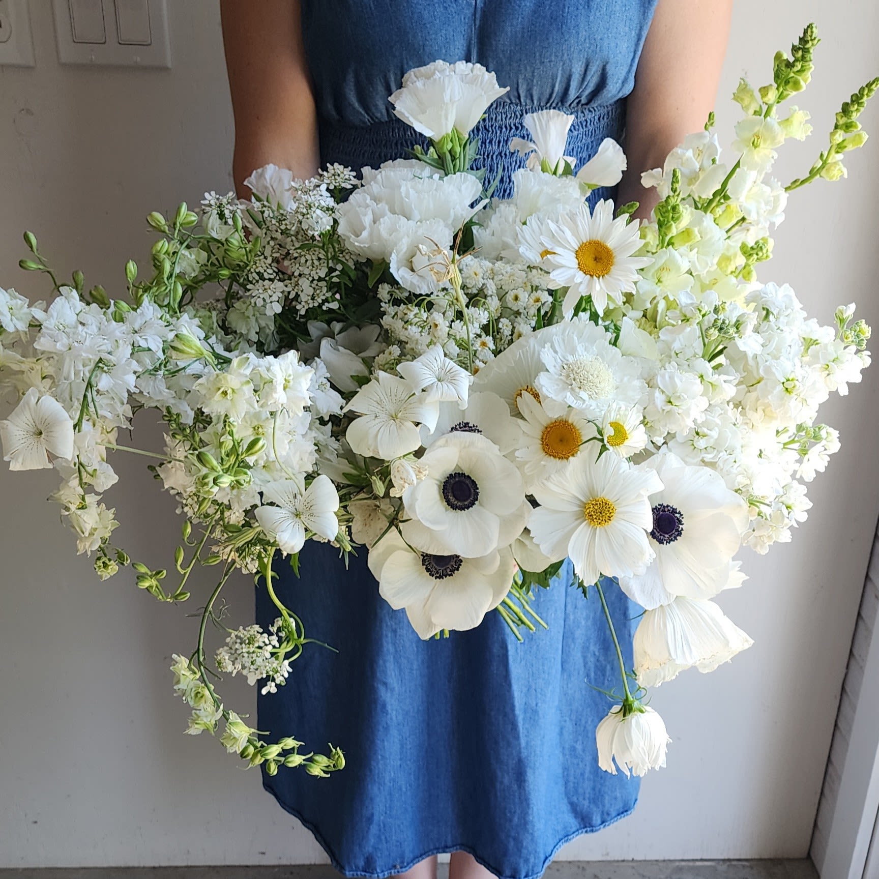 Soft Symphony - ( Gardener's Choice ) - Timeless and elegant, this classic white floral arrangement combines soft, graceful blooms grouped harmoniously for a striking visual impact. Perfect for any occasion, its refined simplicity exudes sophistication and understated beauty.