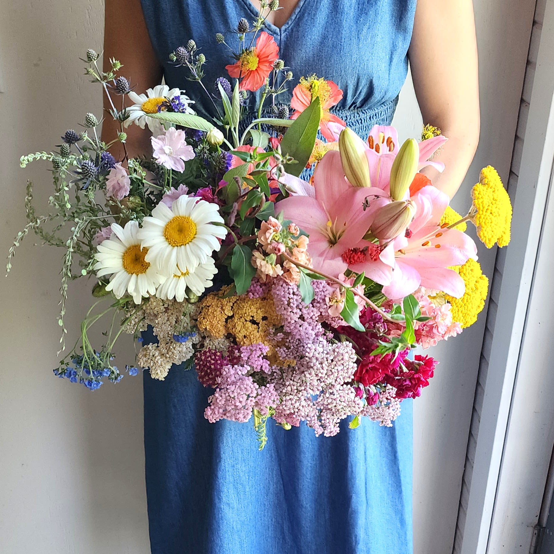 Wildflower Waltz ( Gardener's Choice ) - We are a small studio florist in a small town. Every bouquet we create is a one-of-a-kind creation available. The photos do not represent the exact flowers that will be delivered. They are intended to provide you with an idea of  the variance that can be expected.  The season, availability of flowers,interpretation, and the current materials available. 