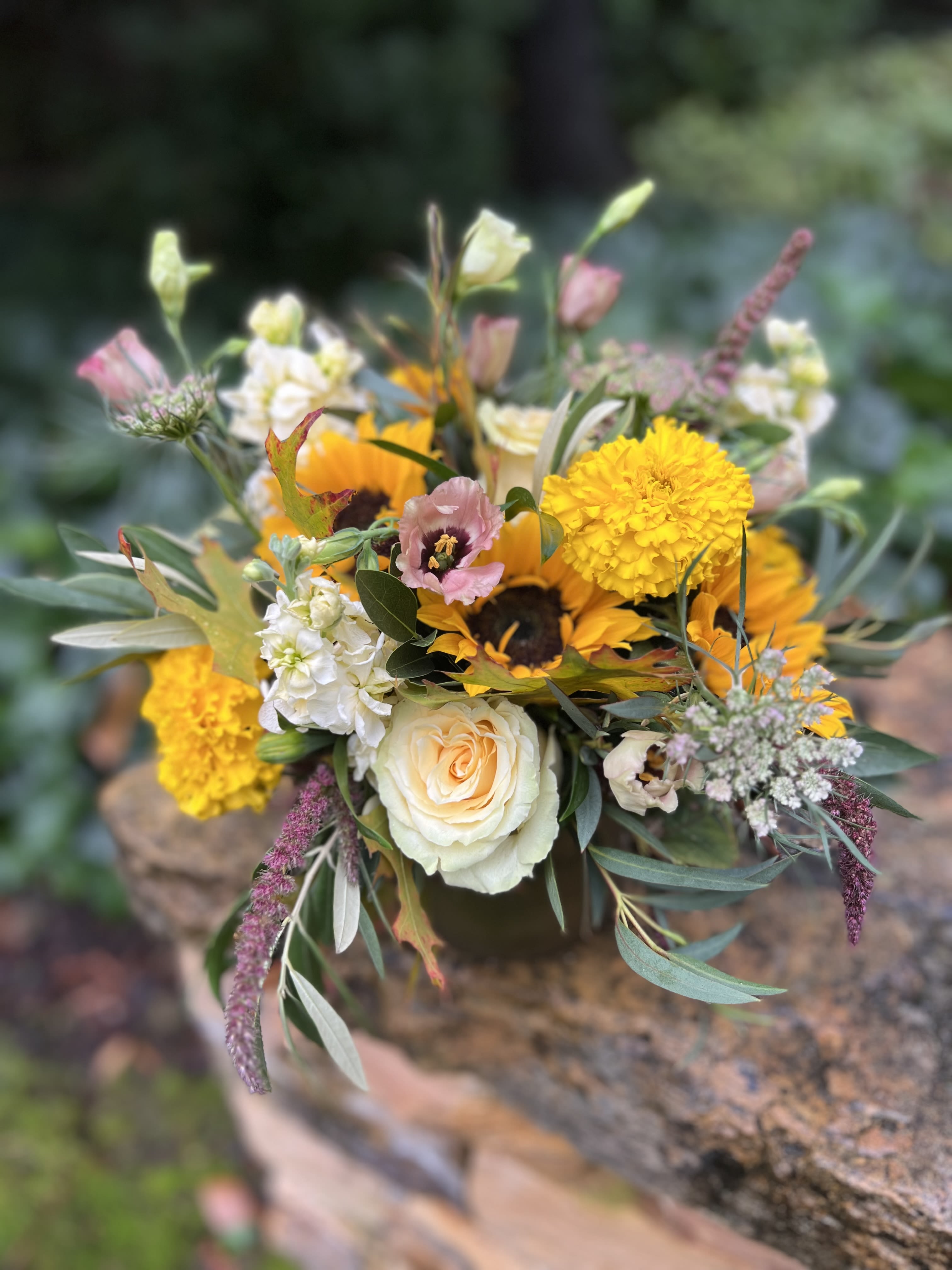 Golden Hour  - Warm yellows and browns in this cutie filled with sunflowers, roses, stock, ranunculus, marigolds, and brown lisianthus designed in a brushed gold container. 