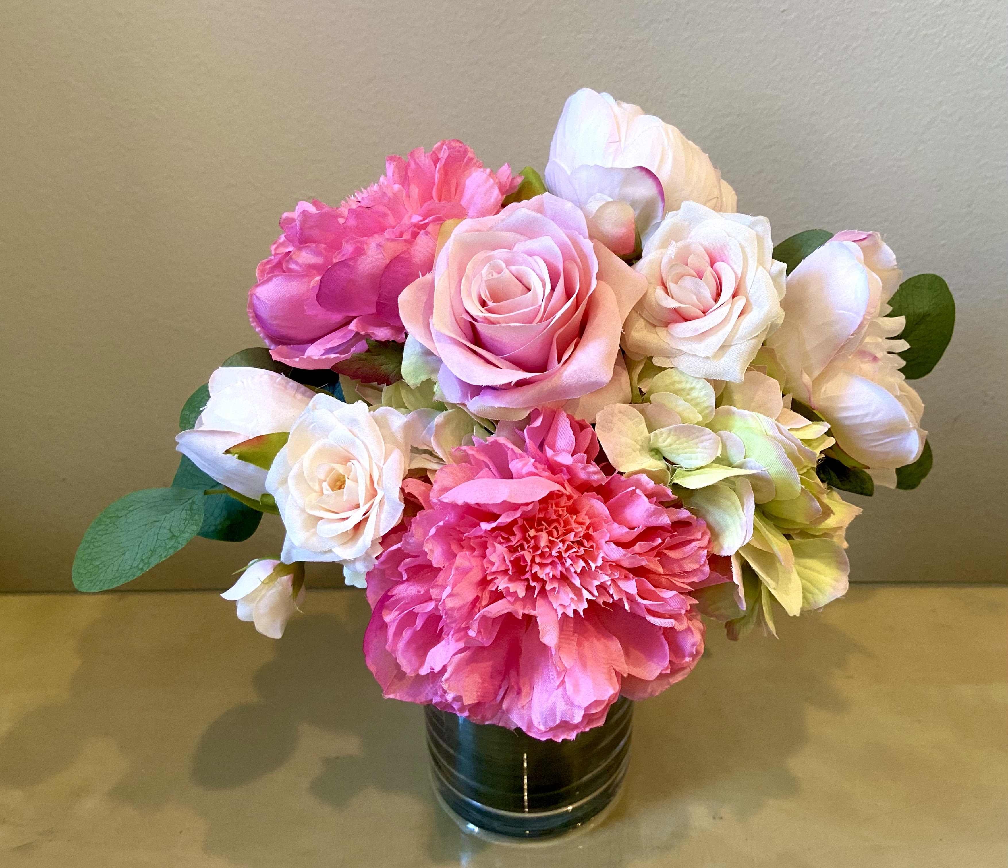 Delicious - Silk Floral Arrangement - Delectable combination of deep pink peonies, blush peonies, roses, spray roses and hydrangea in a clear glass vase with a foliage wrap.