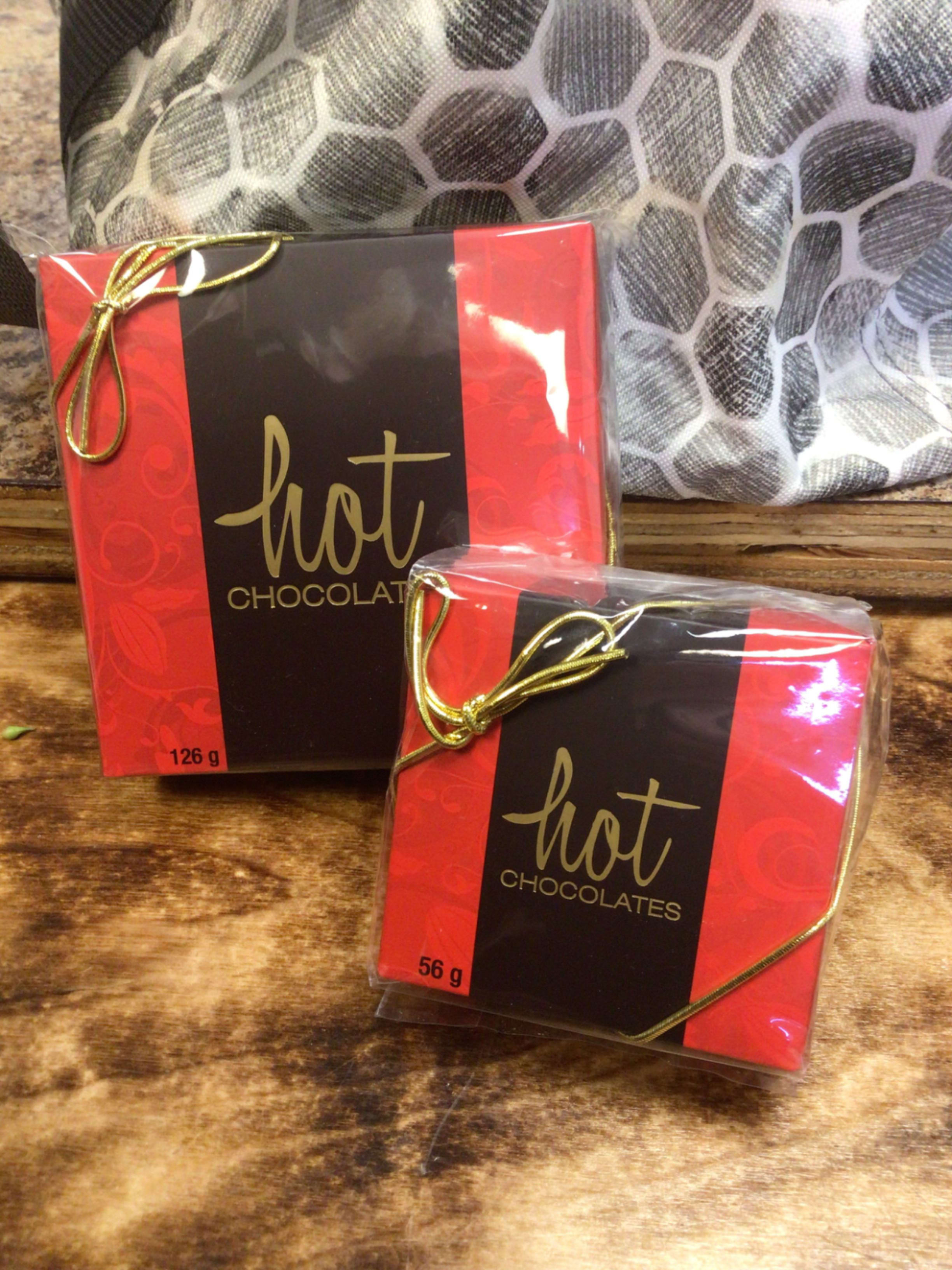 Two boxes of hot chocolates tied with gold ribbon