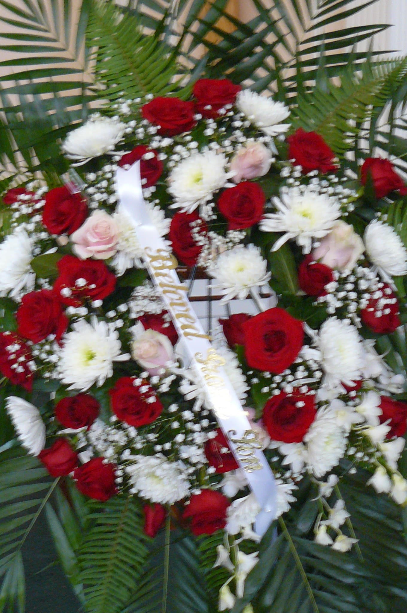 Red and white floral spray with roses and daisies