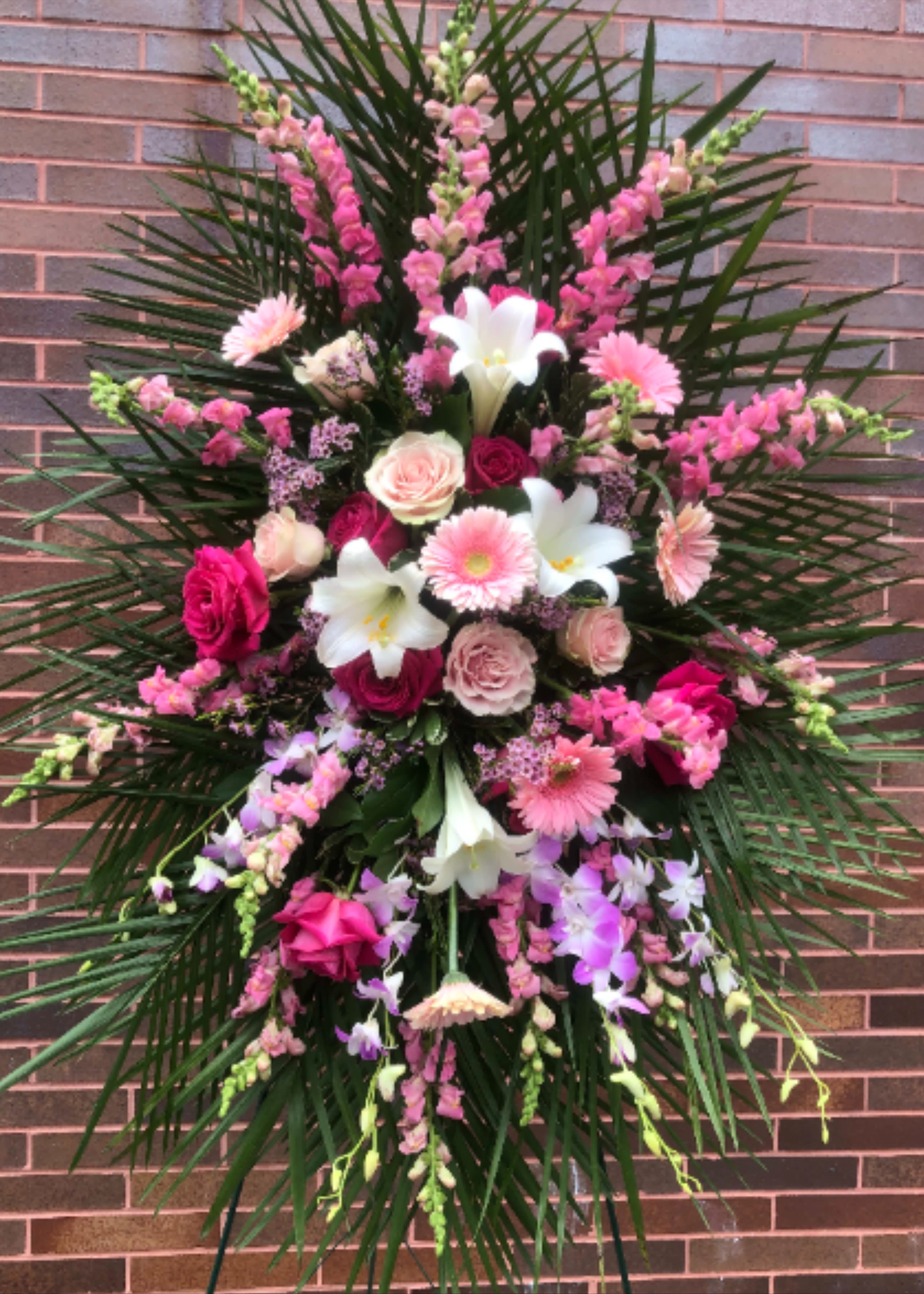 Large pink and white floral standing spray with lilies and roses