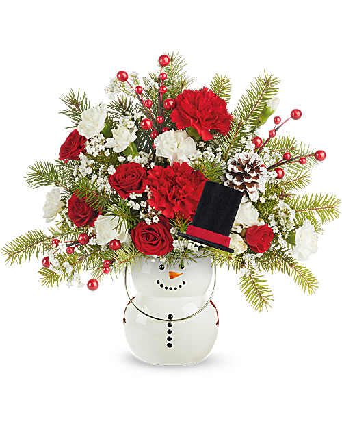 Teleflora's Send A Hug Frosty Magic Bouquet - Teleflora's Send A Hug® Frosty Magic Bouquet delivers festive fun with a cheerful twist! Red and white blooms are hand-arranged with winter greens and bright accents in Teleflora's Send A Hug® Frosty Magic Lantern. This Christmas arrangement adds a whimsical touch to holiday décor.