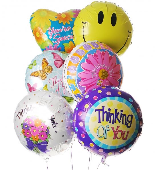 Cluster of colorful foil balloons with floral prints and thank-you messages