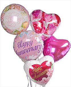 Cluster of heart-shaped and round anniversary balloons in pink and white