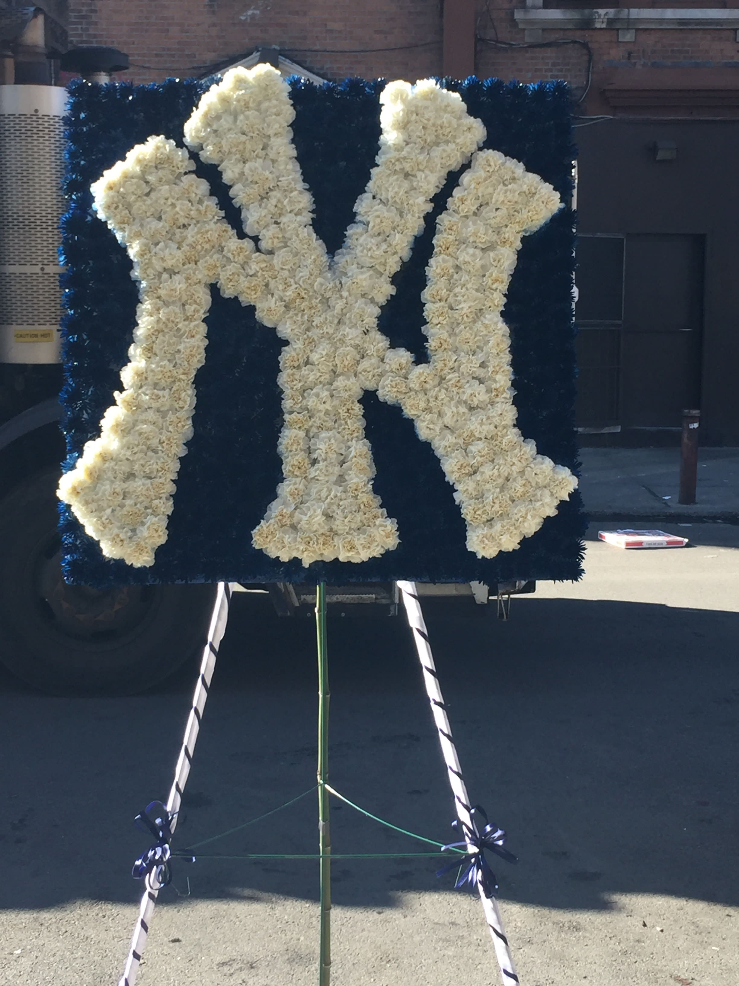 White floral monogram on a dark blue display board