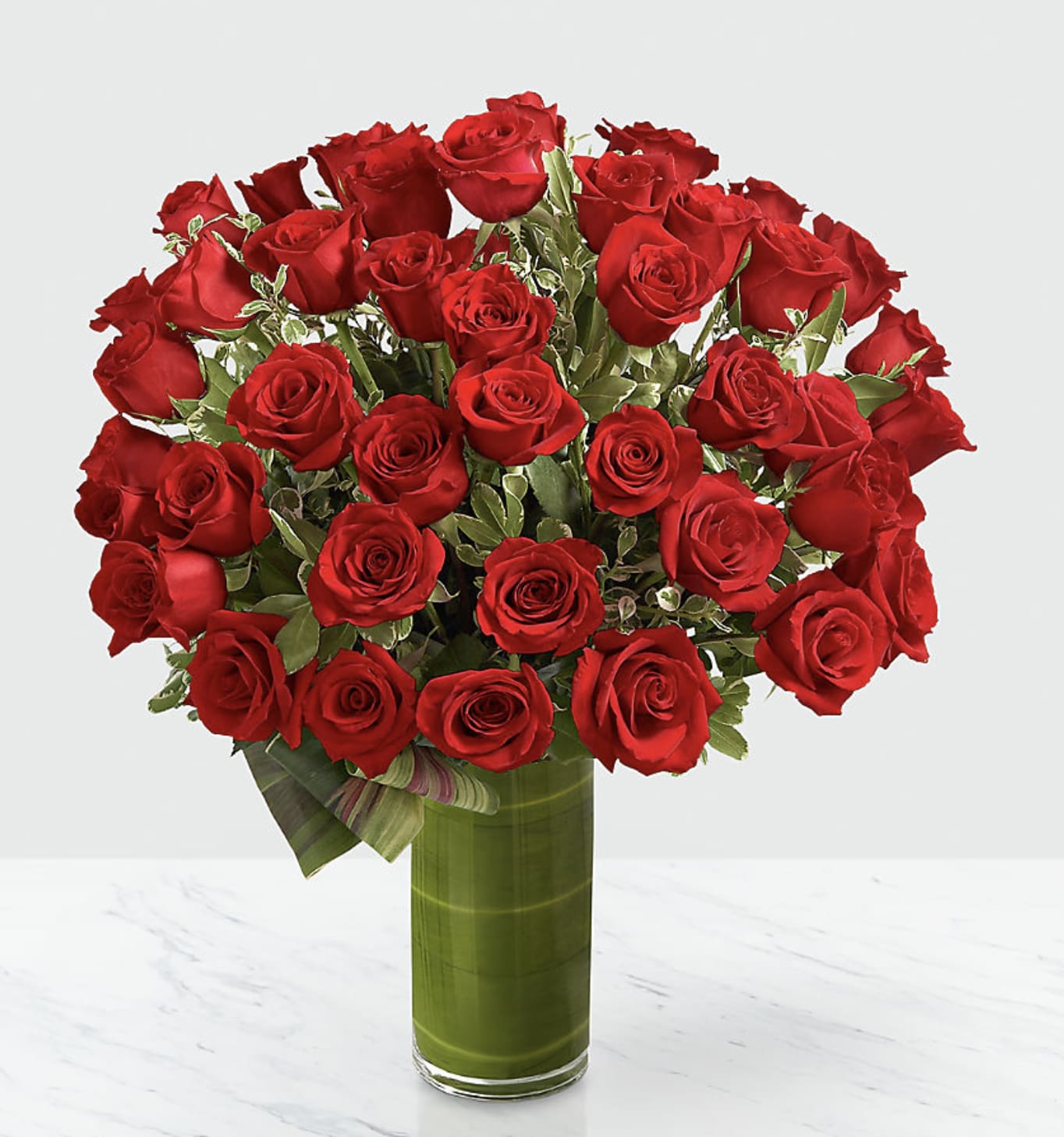 Bouquet of red roses in a tall glass vase