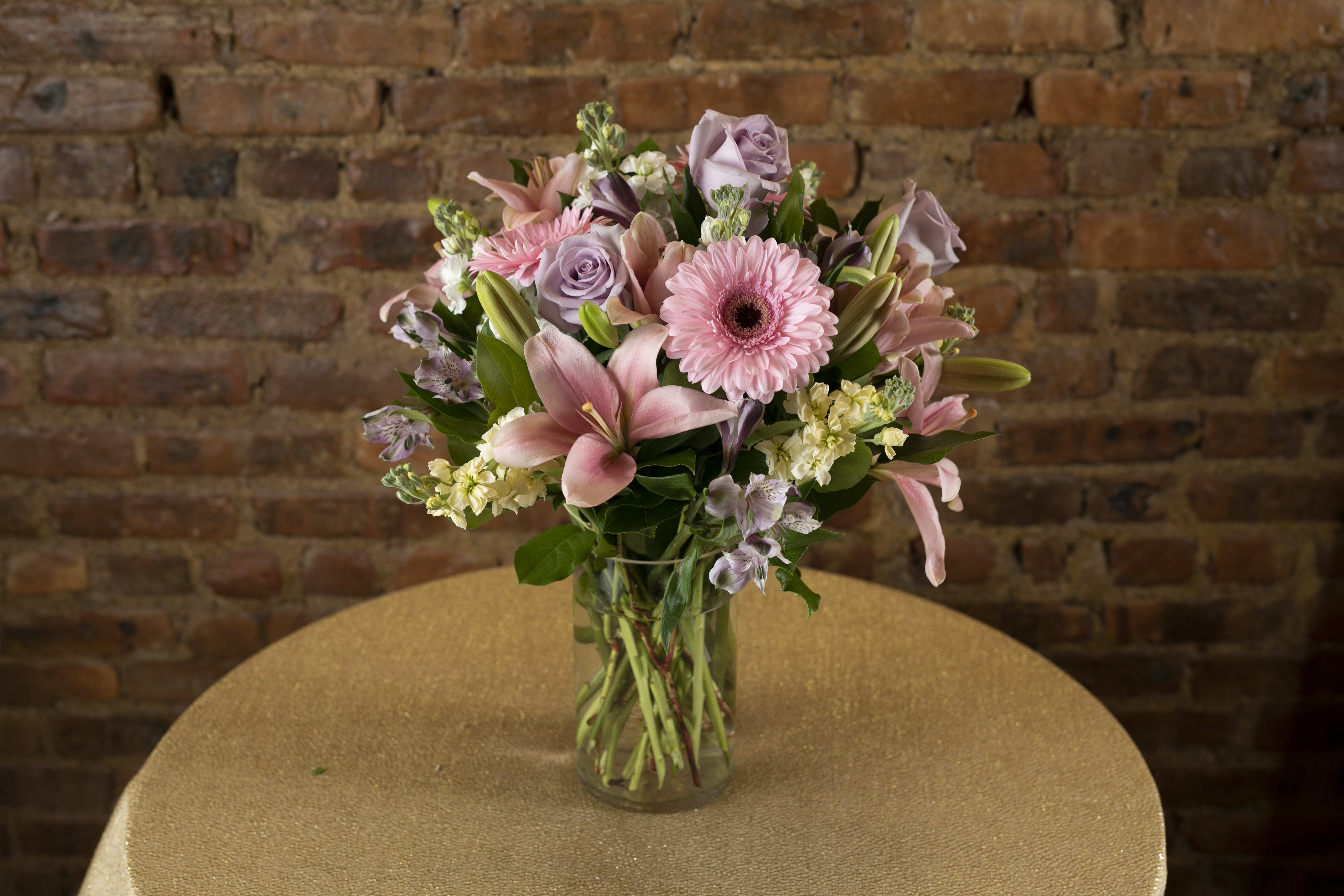 Pink and lavender mixed bouquet in a clear glass vase