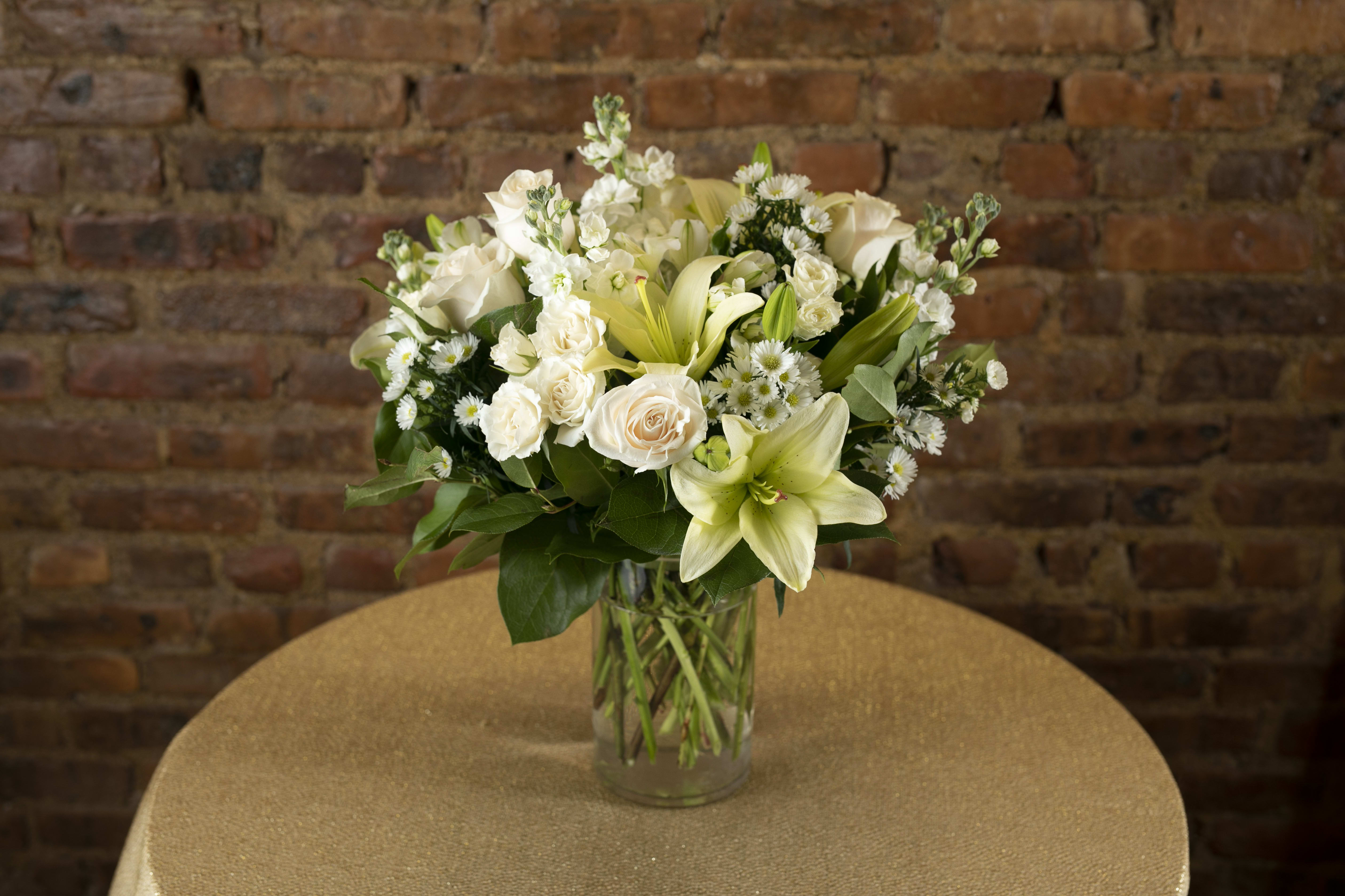 White floral arrangement in a clear glass vase