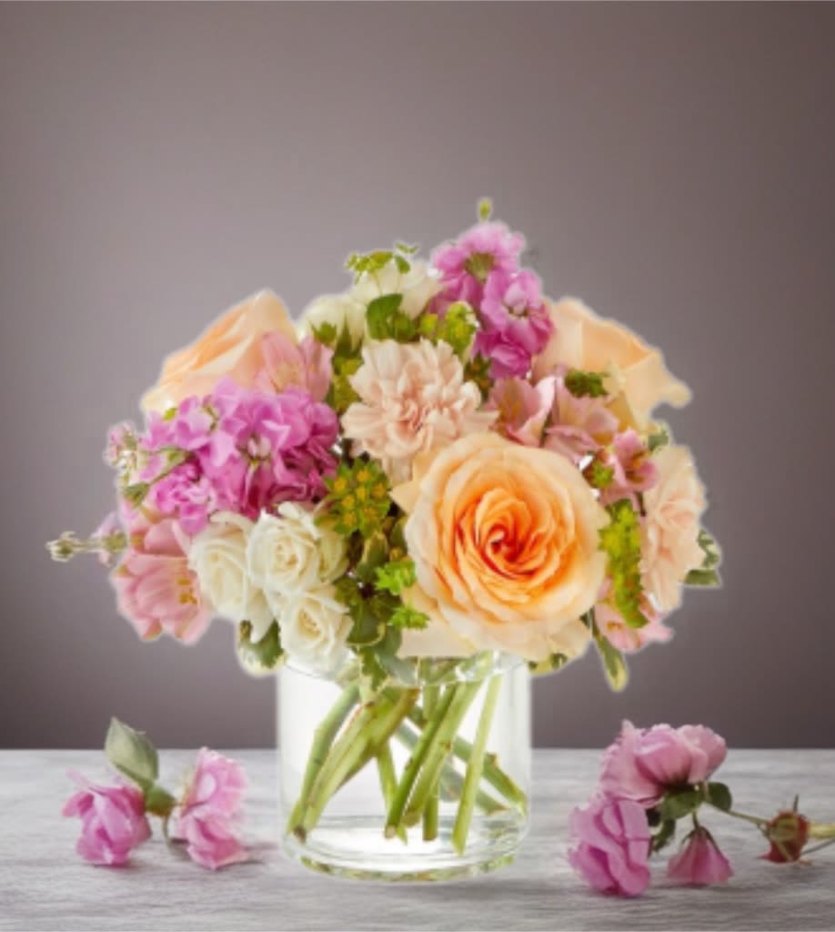 Peach and pink flower bouquet in a clear glass vase