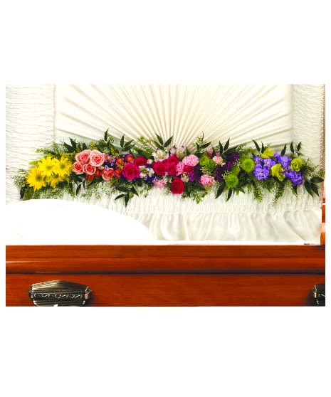 Colorful floral casket spray with roses and daisies