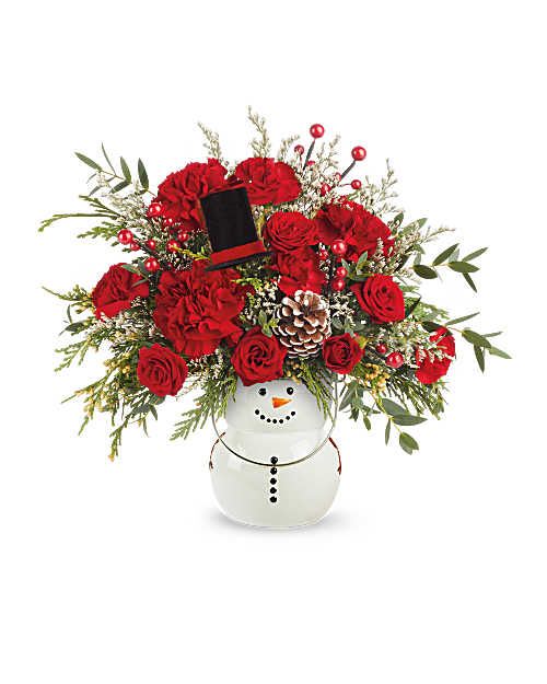 Teleflora's Send A Hug Frosty Glow Bouquet - Teleflora's Send A Hug® Frosty Glow Bouquet lights up the season with vibrant red blooms and festive greens. Hand-arranged in Teleflora's Send A Hug® Frosty Magic Lantern, this Christmas arrangement brings cheerful character to any space-and becomes a glowing lantern after the flowers are gone.