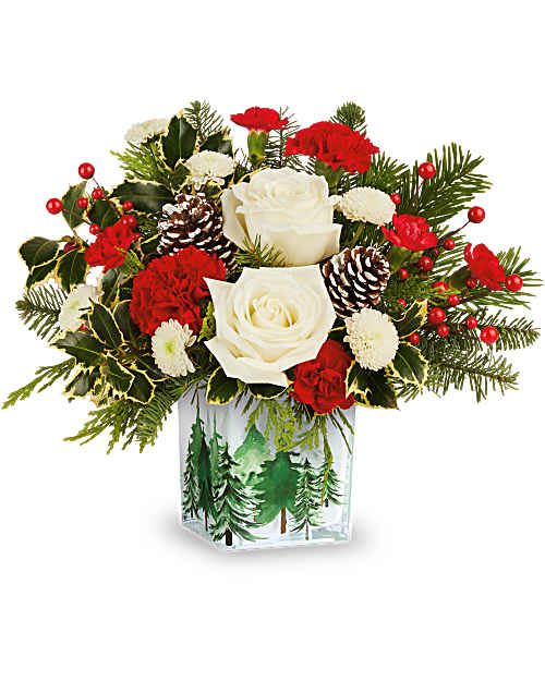 Teleflora's Evergreen Glow Bouquet - Teleflora's Evergreen Glow Bouquet brings classic Christmas color to life with crisp whites, rich reds, and lush greens. Hand-arranged in Teleflora's Evergreen Glow Votive, this festive arrangement casts a warm, inviting feel for holiday décor.