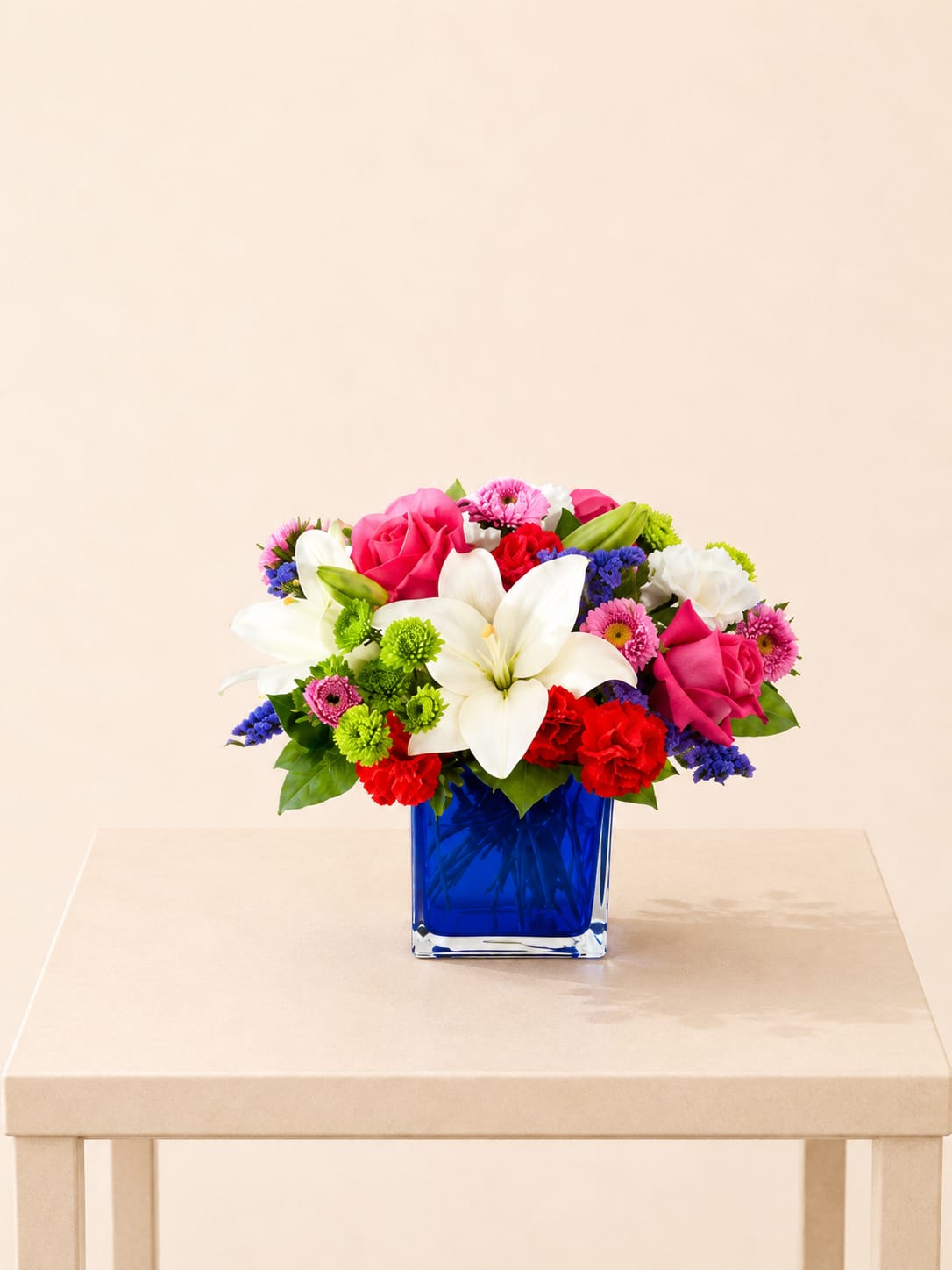 Vibrant &amp; Blue Centerpiece - A lively and colorful arrangement that adds a touch of joy and style to any table.  Each piece is Designer’s Choice, created with fresh seasonal blooms. Flowers and colors may vary based on availability while maintaining the overall style and quality.  Best for: brightening family dinners, elevating baby showers, or enhancing casual celebrations. 