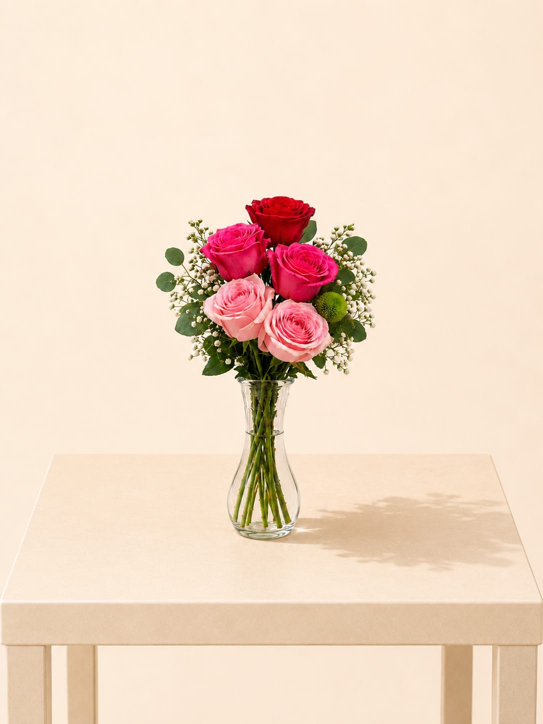 Pink Kiss Bud Vase - A sweet and romantic flower arrangement featuring a beautiful mix of blush and hot pink roses, finished with airy baby’s breath and fresh greenery. Designed in a tall clear glass vase, this piece creates a soft, elegant, and uplifting presence.  Each arrangement is Designer’s Choice, thoughtfully created with fresh seasonal blooms. Flower varieties and color tones may vary based on availability while preserving the overall style, palette, and quality.  Perfect for Valentine’s Day, anniversaries, birthdays, romantic gestures, thinking of you, Mother’s Day, or a heartfelt “just because” surprise.  Same day flower delivery available in Southwest Florida, including Naples, Bonita Springs, and Fort Myers Beach. 