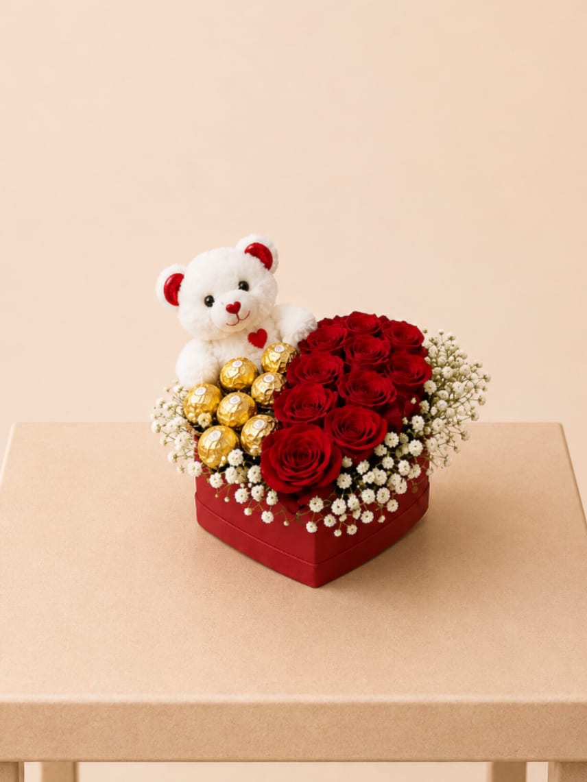 Forever Yours - A stunning heart-shaped flower arrangement featuring velvety red roses and delicate baby’s breath, beautifully paired with Ferrero Rocher chocolates and a soft plush bear. A luxurious and heartfelt gift designed to impress and create unforgettable moments.  Each arrangement is Designer’s Choice, thoughtfully created with fresh seasonal blooms. Flower varieties and color tones may vary based on availability while preserving the overall style, palette, and presentation.  Perfect for Valentine’s Day, anniversaries, romantic gestures, congratulations, or a meaningful “just because” surprise.  Same day flower delivery available in Southwest Florida, including Naples, Bonita Springs, and Fort Myers Beach.