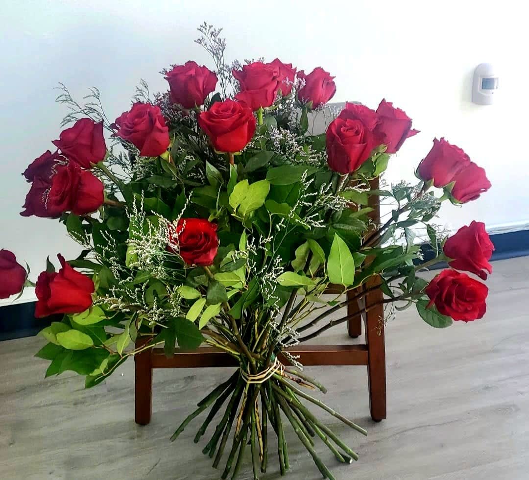 Large bouquet of red roses with greenery and filler