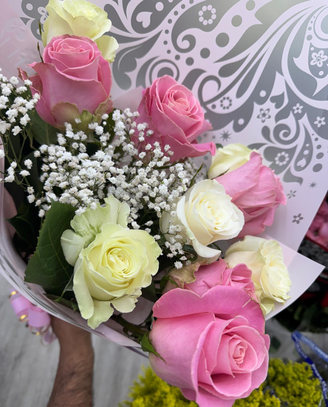 Bouquet of pink and pale yellow roses with baby's breath