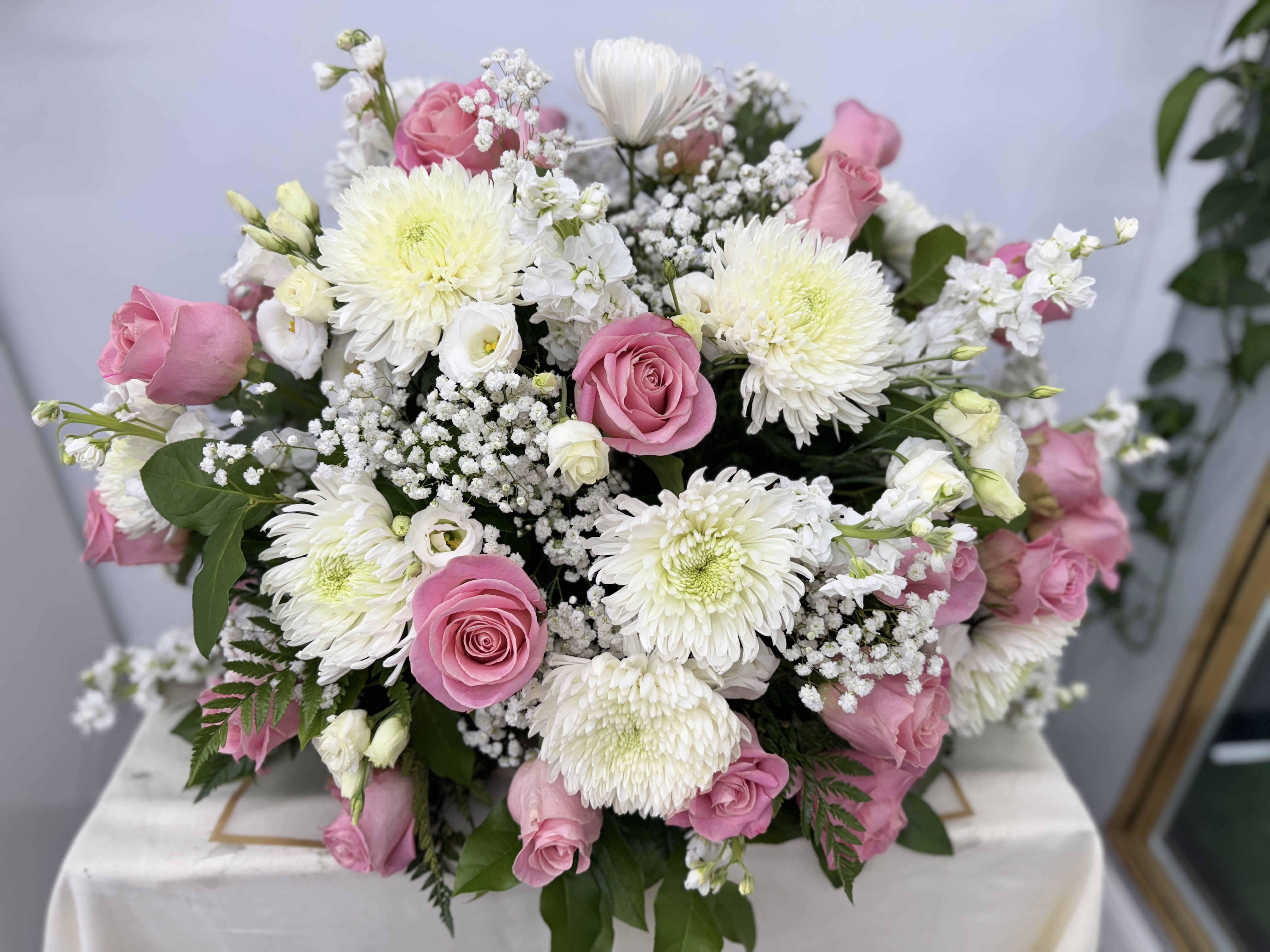 Pink roses and white chrysanthemums arranged in a low bouquet
