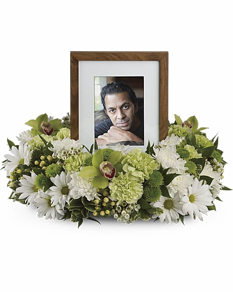 Framed photo surrounded by white and green flowers