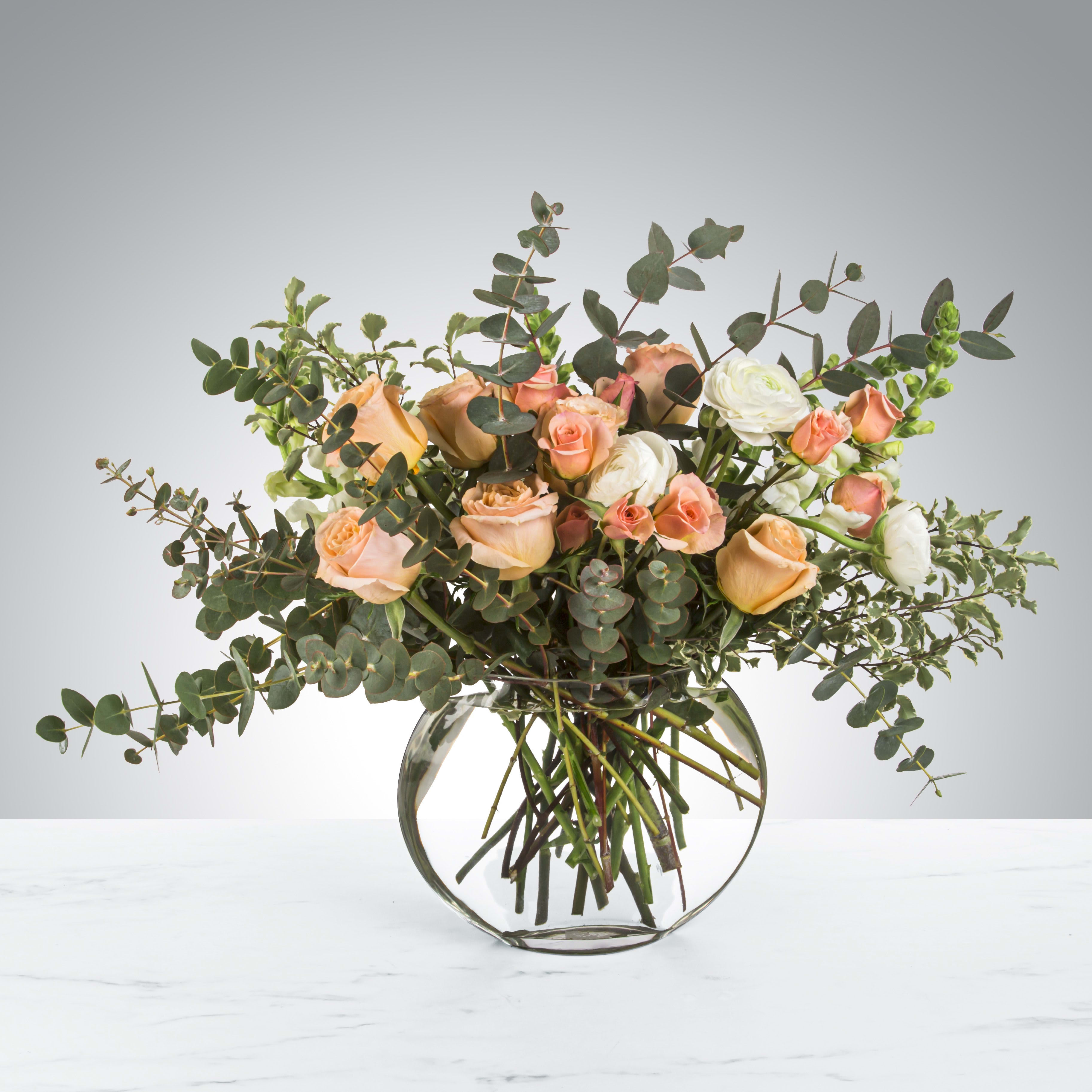 Sugar by BloomNation™ - Sugar by BloomNation™ is the most whimsical way to sweeten somebody's day. This beautiful boho arrangement with eucalyptus, peach roses, and white ranunculus in a moon shaped vase elevates any space. Perfect for Women's Day, Mother's Day, or any birthday.   APPROXIMATE DIMENSIONS: 22" W x 20" H