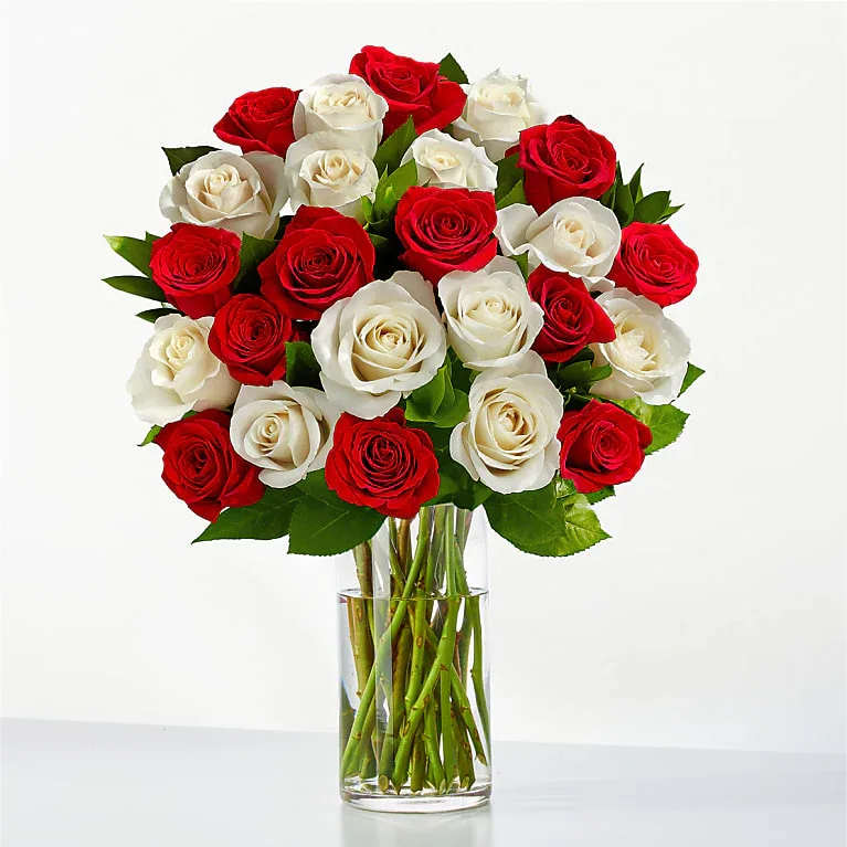 Bouquet of red and white roses in a clear glass vase