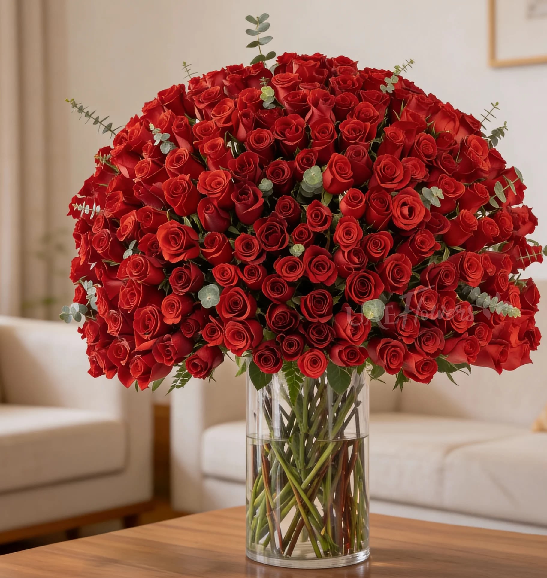 Large bouquet of red roses in a clear glass vase