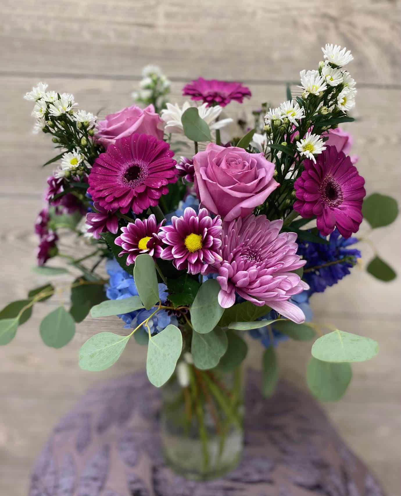 Lavender Meadow - A "just picked" from the meadow mix of lavender roses, daisies, gerbera, asters and eucalyptus.  