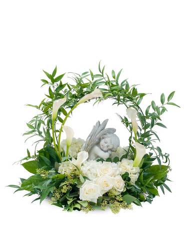 White roses and calla lilies arranged around a small angel figurine