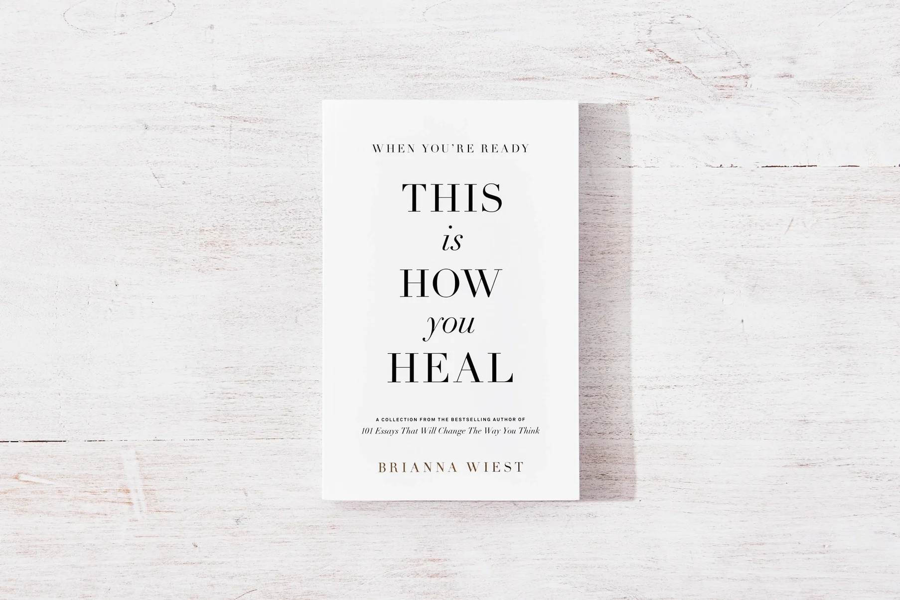 A book titled "This Is How You Heal" on a white wooden surface