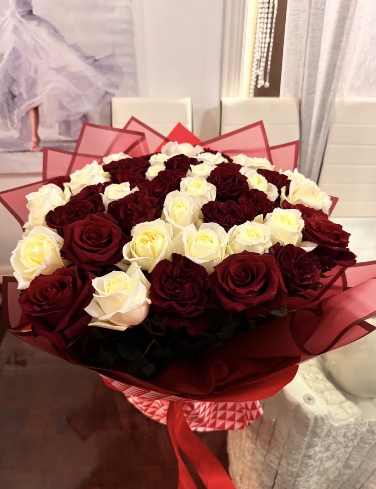 Eclipse - A bouquet that feels like a slow dance between fire and moonlight. Deep crimson roses unfold like velvet secrets- rich, dramatic, unforgettable- while ivory/ white roses soften the composition with calm elegance and quiet devotion.  The contrast is magnetic: red for passion, ambition, and intensity; white for grace, clarity, and loyalty. Perfect for grand romantic gestures, anniversaries, "I choose you" moments, or someone whose presence change the atmosphere when they enter a room. 