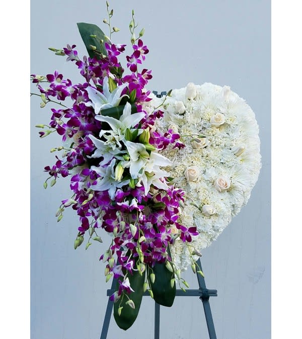 Standing floral spray with white lilies, purple orchids, and white roses