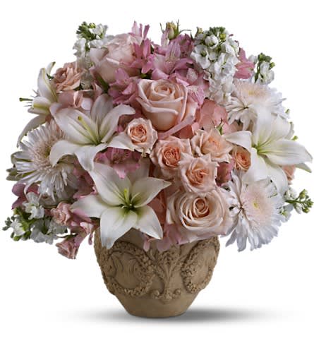 Pink and white floral arrangement in an ornate vase