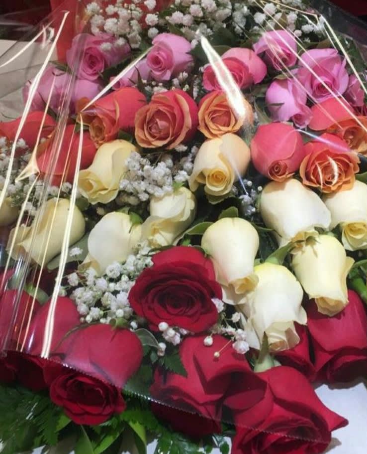 Bouquet of roses in red, pink, cream, and peach tones