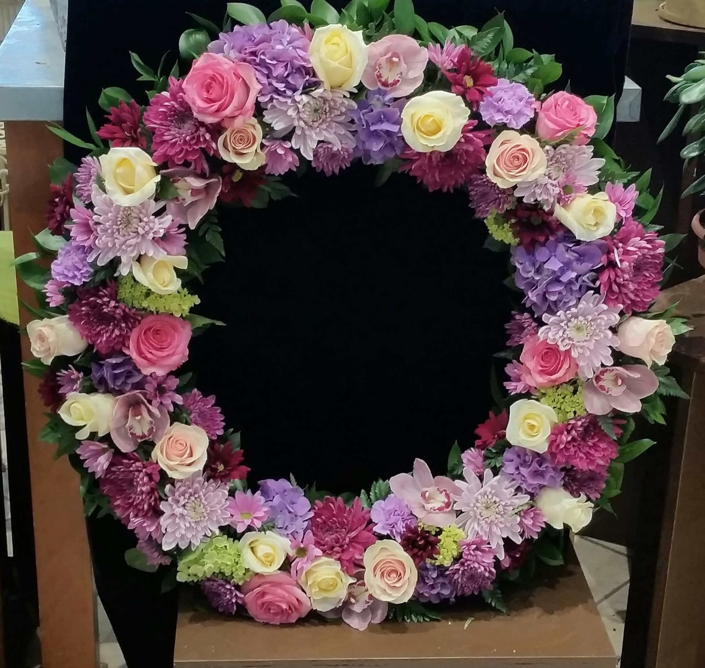 Heart-shaped floral wreath with pink, purple, and white blooms