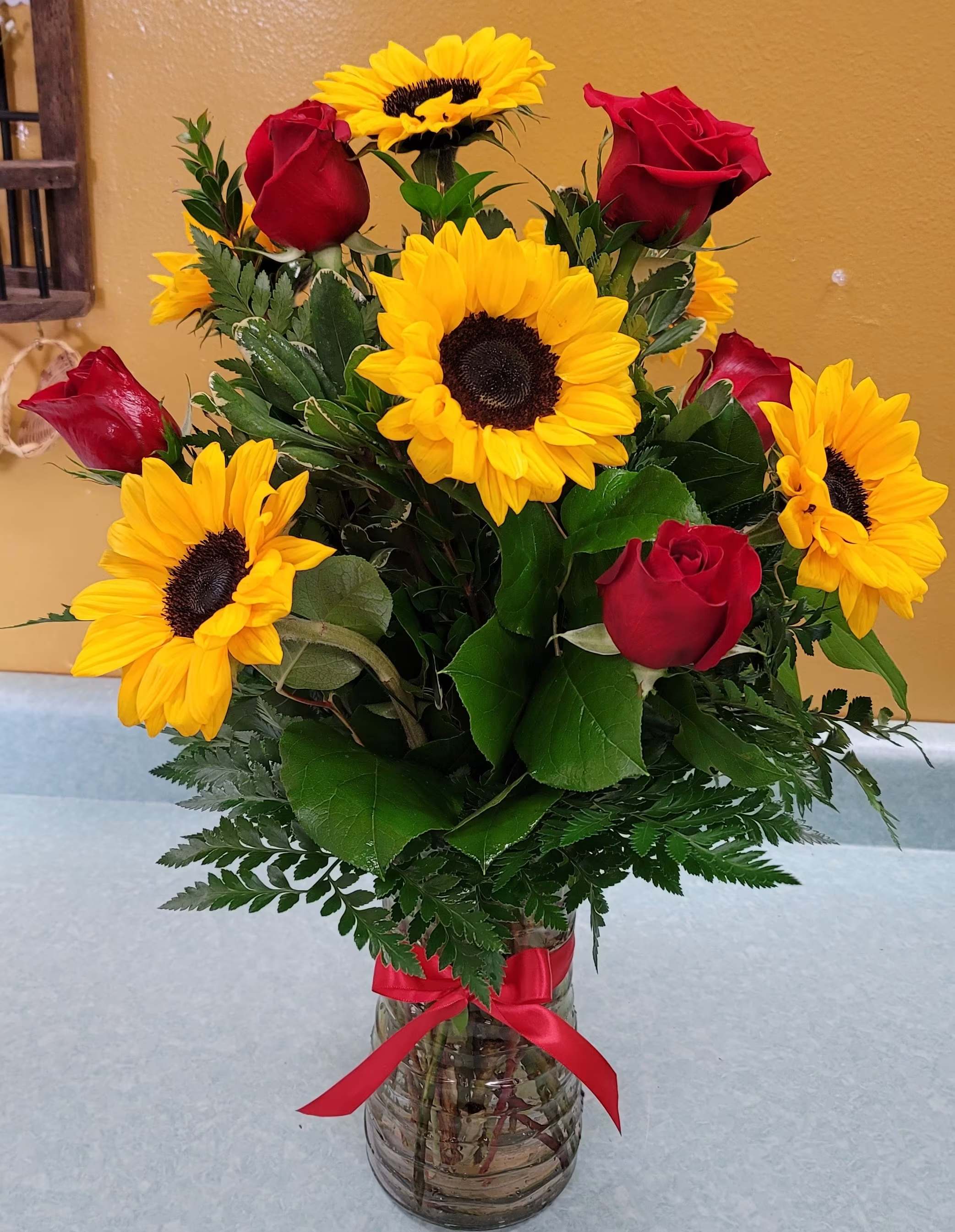 Passionate About You!!  - Sunflowers (two different sizes), red roses, greenery and clear vase. 