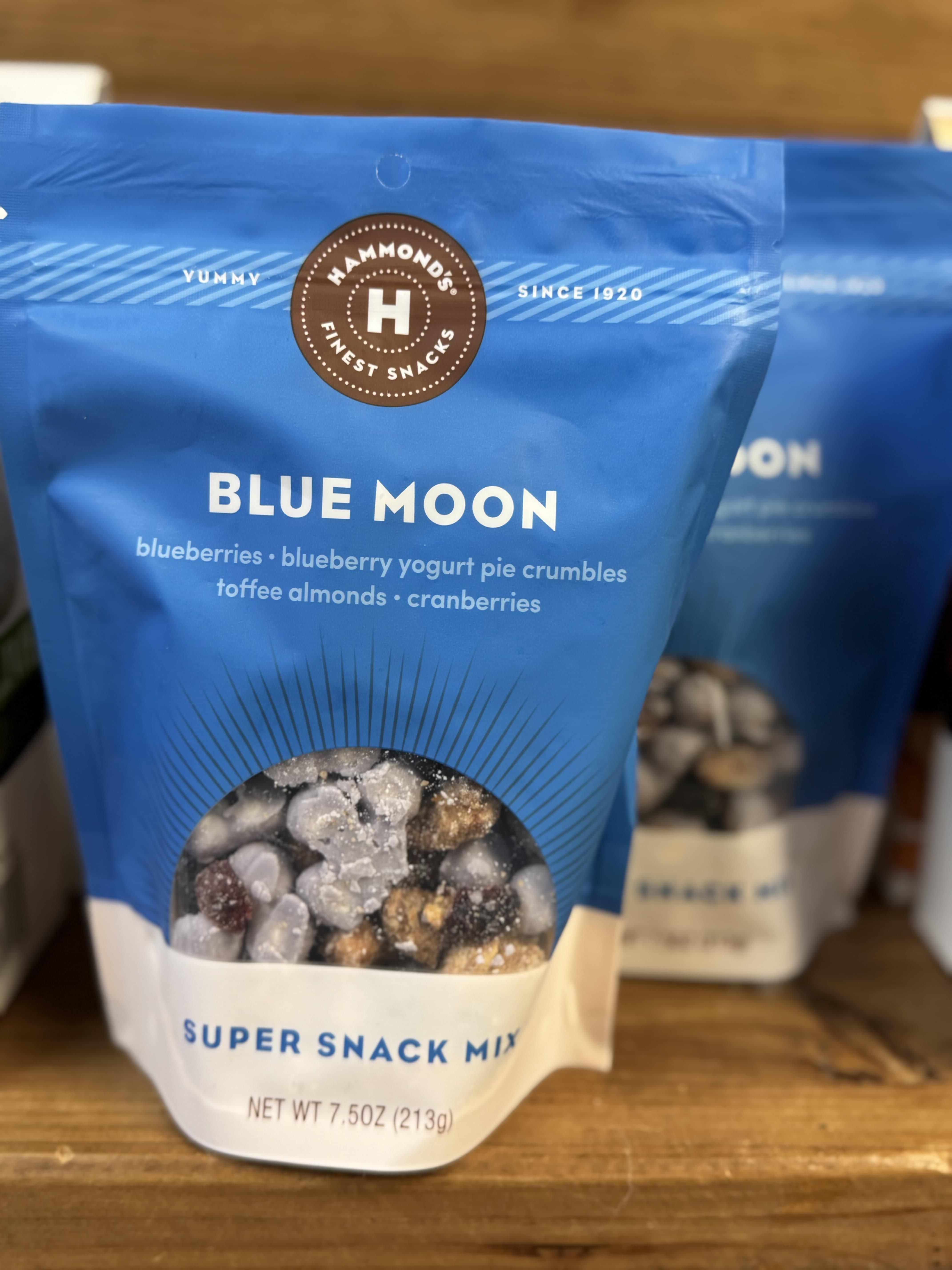 Blue snack mix bag with a clear window showing nuts and dried fruit
