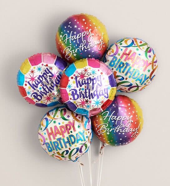 Cluster of colorful Happy Birthday balloons on sticks