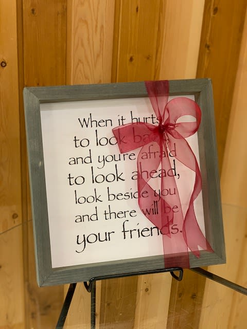 Framed quote sign with a pink ribbon bow