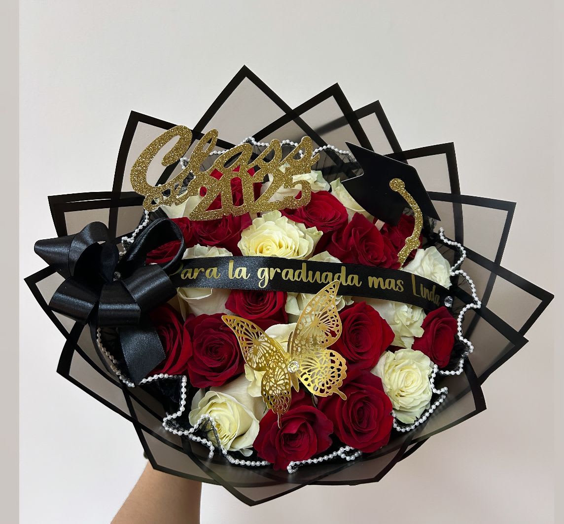 Bouquet of red and white roses with graduation decorations