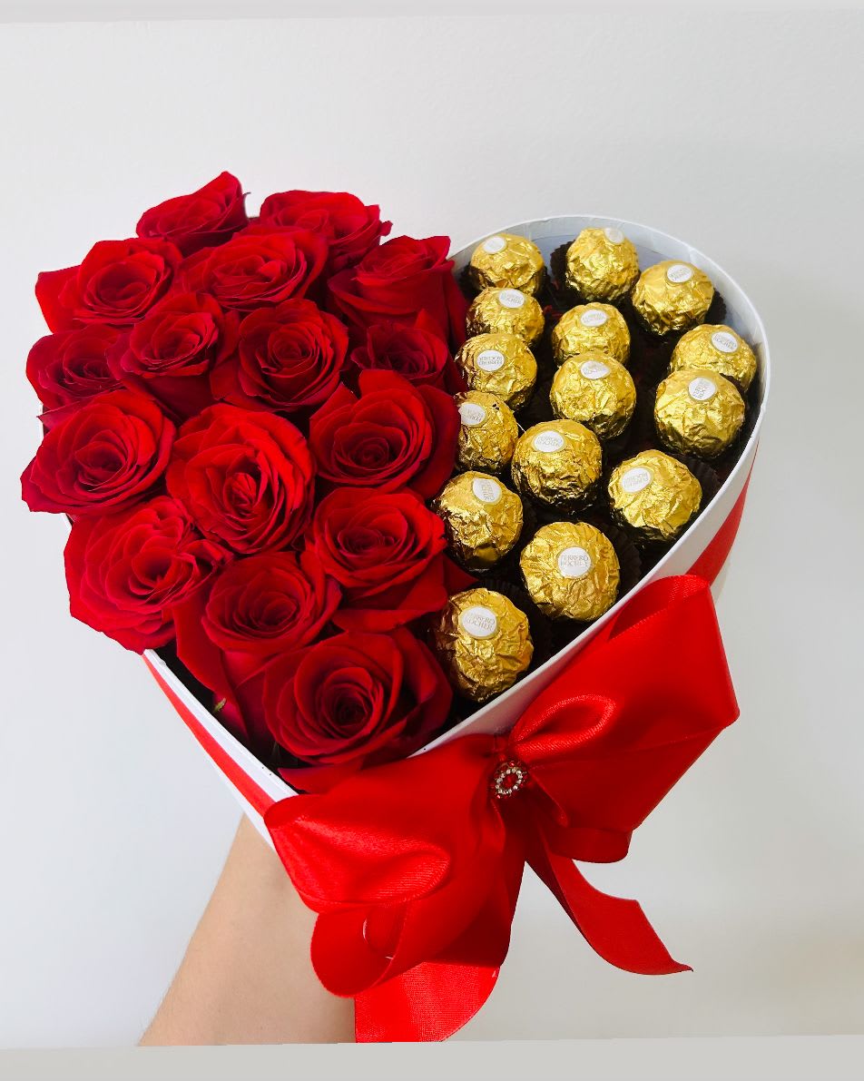 Heart-shaped box with red roses and gold-wrapped chocolates