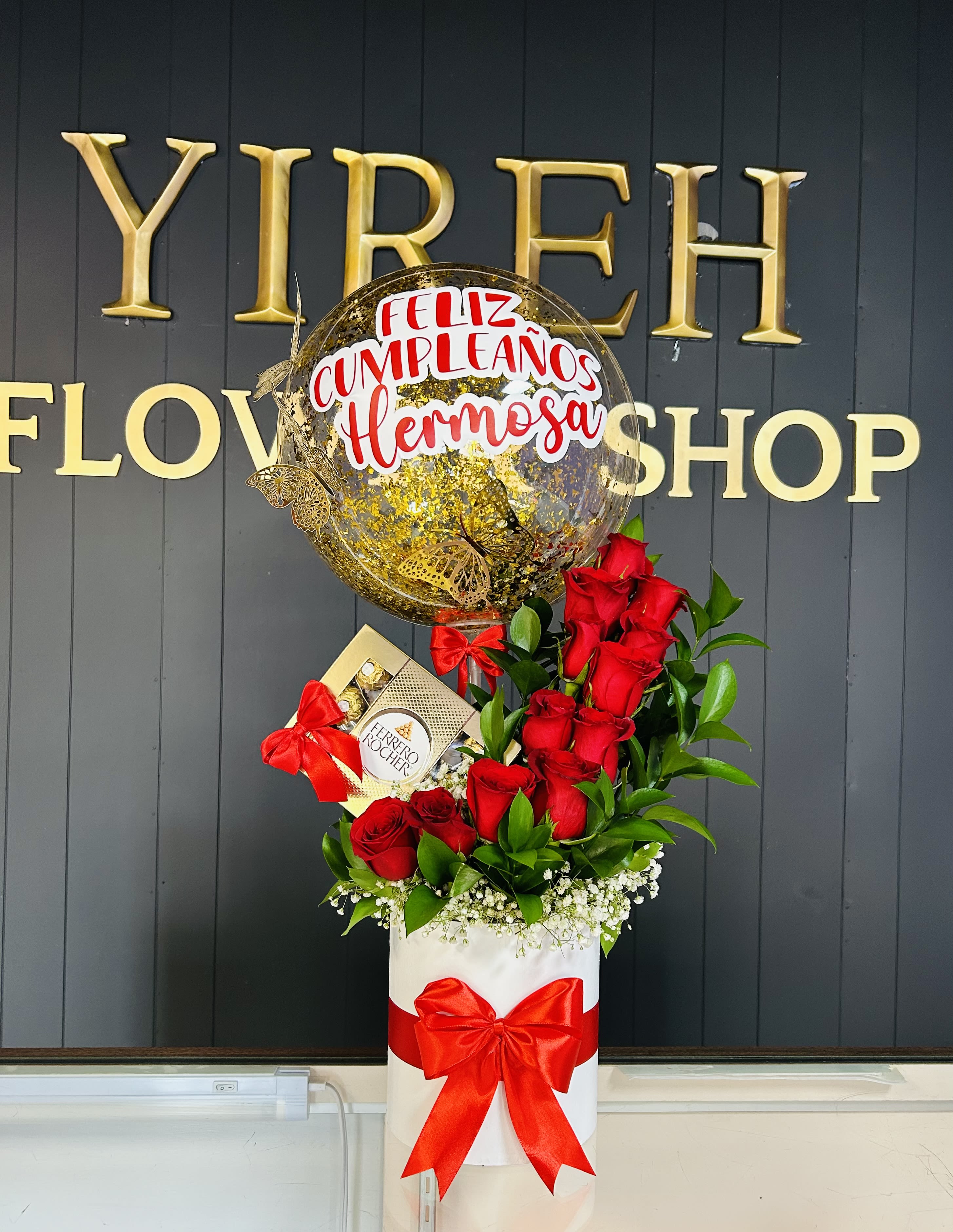 Red roses with a birthday balloon and chocolate box in a white gift box