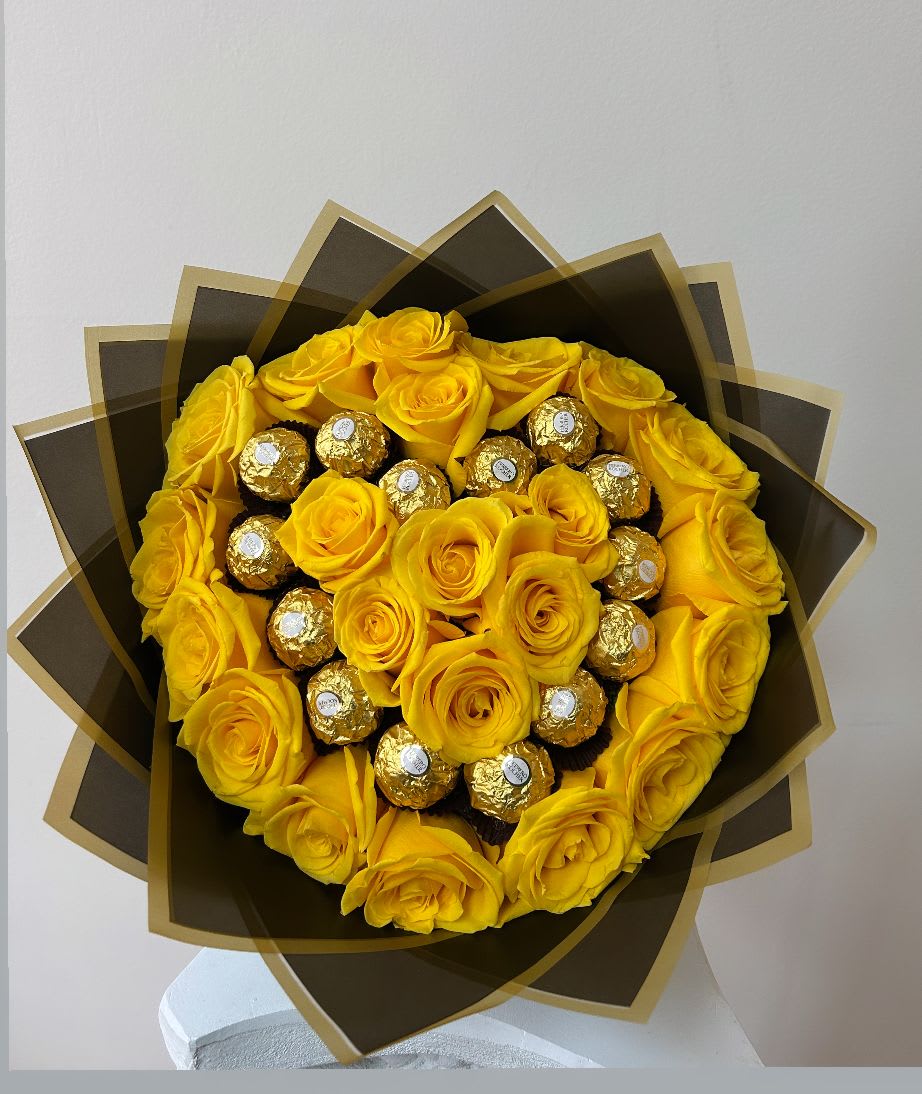 Bouquet of yellow roses with gold-wrapped chocolates