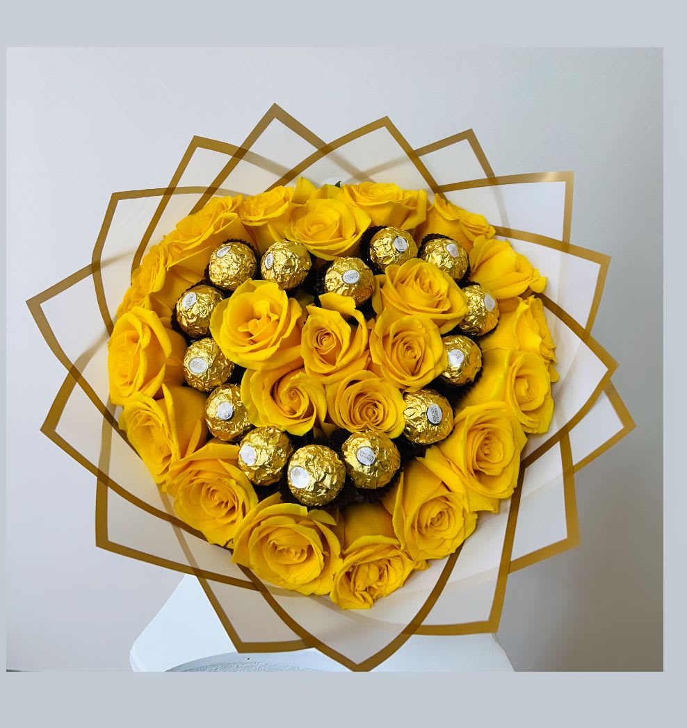 Yellow rose bouquet with gold-wrapped chocolates in a decorative wrap