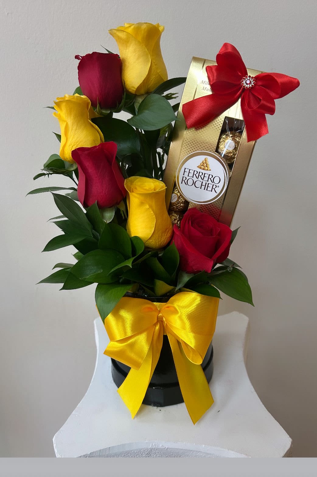Red and yellow roses with a Ferrero Rocher gift box and ribbon