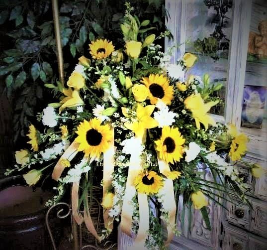 Yellow sunflower arrangement with white flowers and ribbon streamers
